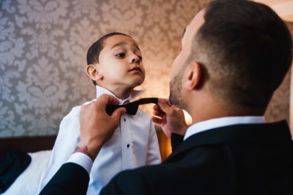 Photojournalistic-Wedding-Photo-_-Father-and-Son-on-Wedding-Day-_-Dad-Helping-Son-With-Tie-_-Kid-Getting-Ready-for-A-Wedding-_-Kid-on-a-Wedding-Day-_-Wedding-Documentary-