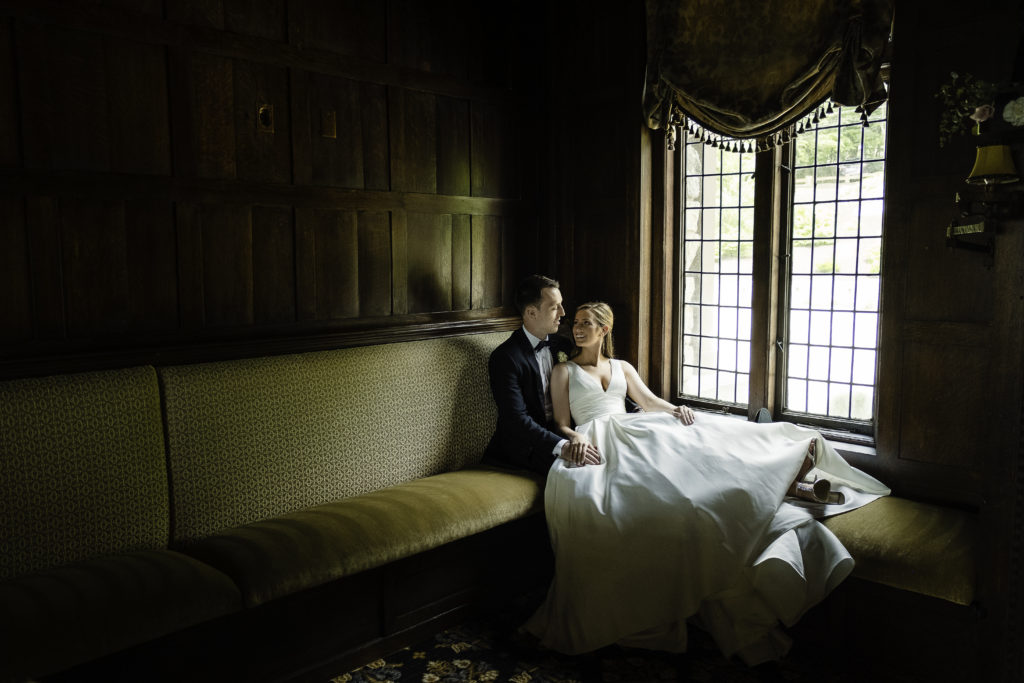 Bride and Groom sitting on couch at Le Chateau - wedding photography