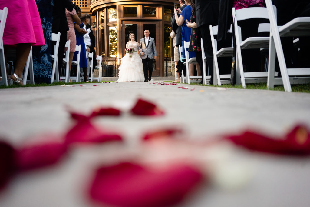 A bride and her father walking down the isle at Le Château