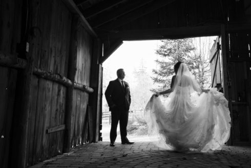 black and white wedding photo inside a barn