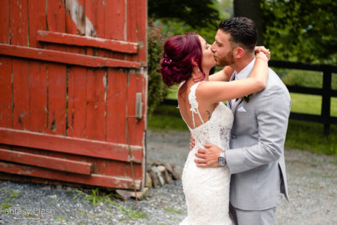 bride and groom photographed in front of barn at falkirk estate and country club