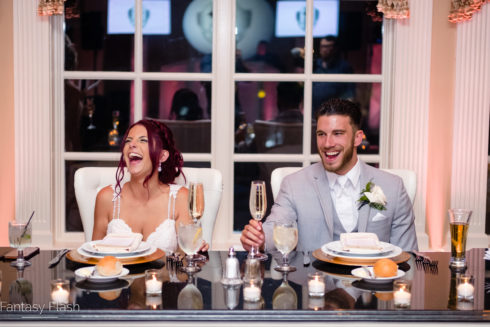 bride and groom sitting at the dais
