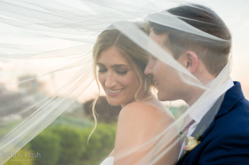 brides veil covering bride and groom