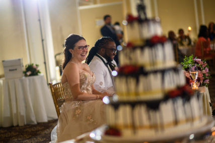Young bride and groom sitting at head table
