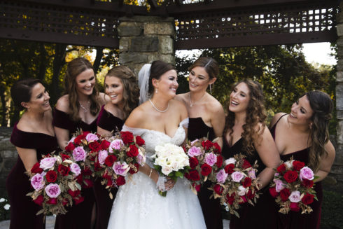 bride posing with bridesmaids at Le Chateau