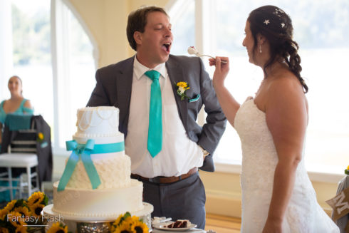 bride feeding groom wedding cake