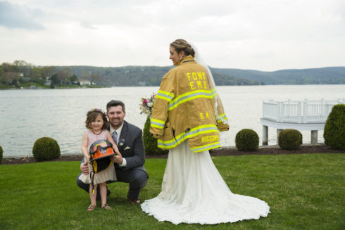 Bride, groom and flower girl taking wedding photos