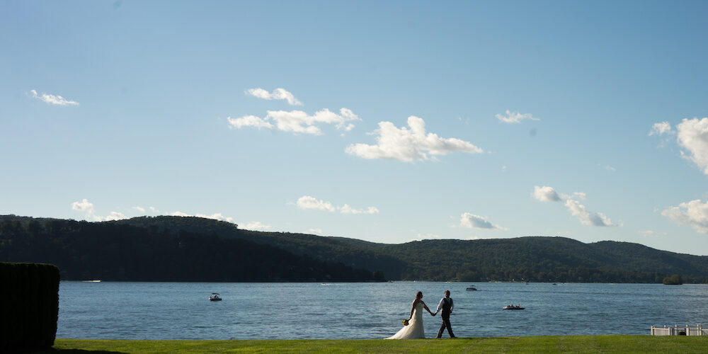 a bride and groom walking by lake Candlewood
