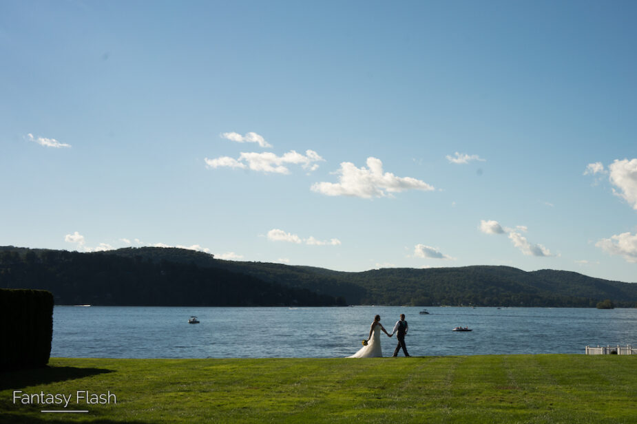 a bride and groom walking by lake Candlewood
