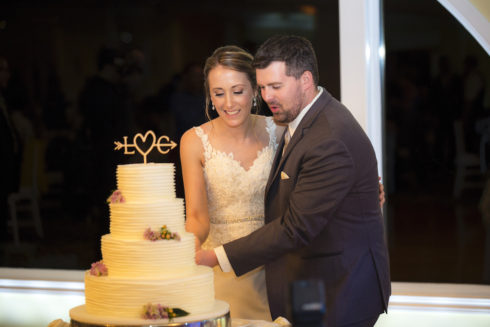 bride and groom cutting the cake