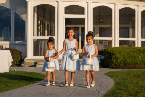 Flower girls walking down the isle at Candlewood Inn