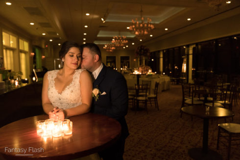 Candid moment of groom hugging bride