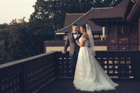 bride and groom on back patio of Le Chateau
