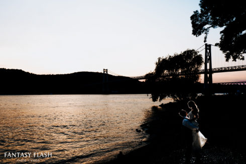 newlywed couple posing near mid-hudson bridge