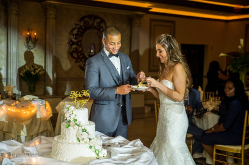 bride and groom eating wedding cake