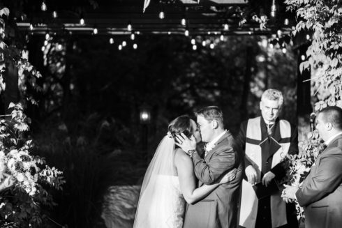bride and groom kissing - outdoor wedding ceremony