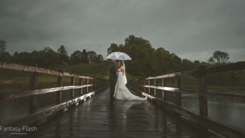 Bride and groom on the bridge at the Hollow Brook Golf Club