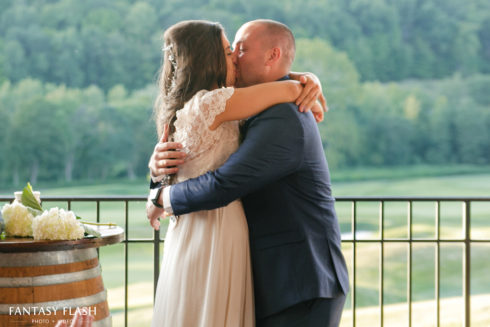 a groom holding bride at Hollow Brook Golf Club