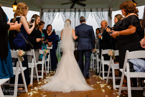 bride walking down the isle at Hollow Brook Golf Club