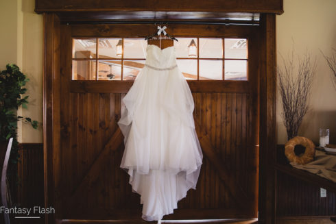 wedding dress hanging on wall