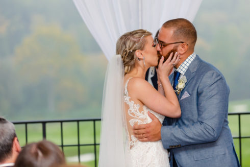 bride and groom kissing at hollow brook golf club