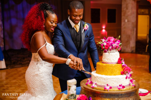 a bride and groom cutting a wedding cake at Anthonys Pier 9