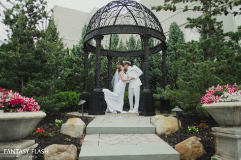 a bride and groom under a gazebo at Anthonys Pier 9