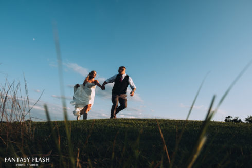 Bride and groom holding hands at New York Country Club