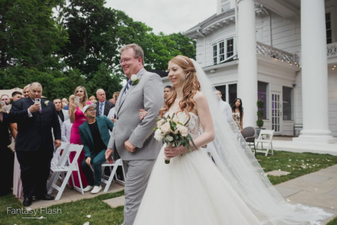 A bride and her father walking down the isle at The Briarcliff Manor