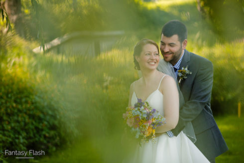 groom holding bride at West Hills Country Club