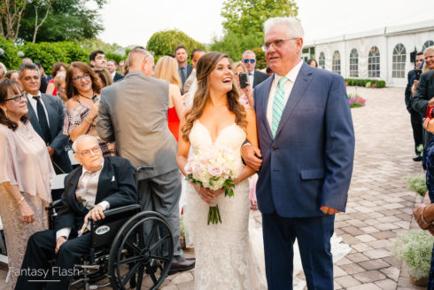 Bride and father walking down the isle at West Hills Country Club