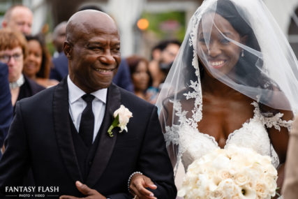 bride walking down the isle at West Hills Country Club